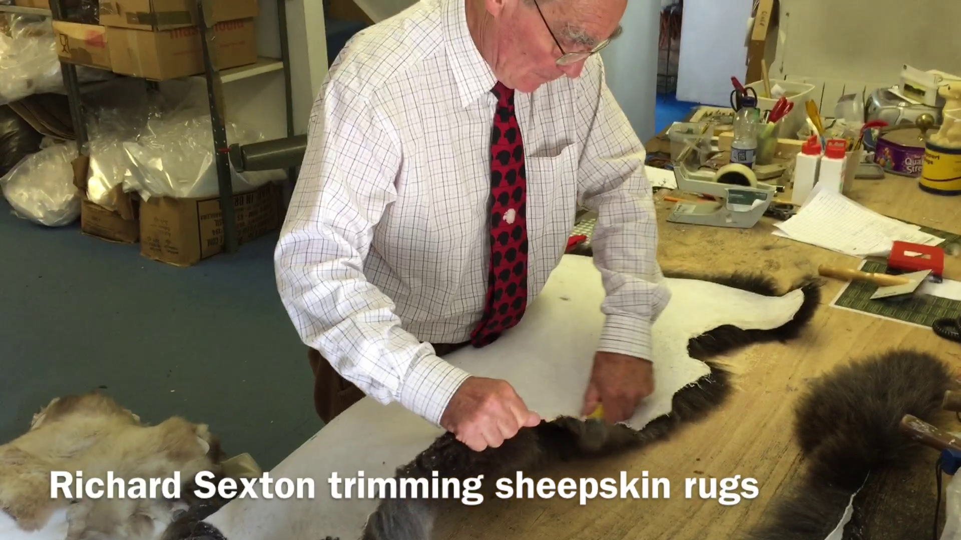 Richard Sexton trimming sheepskin rugs