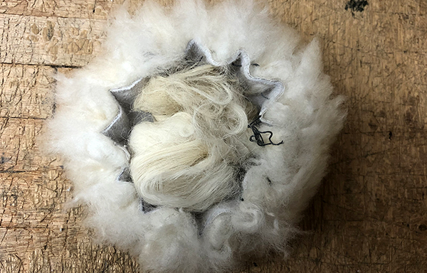 sheepskin circle stuffed with wool to make bobble for hat